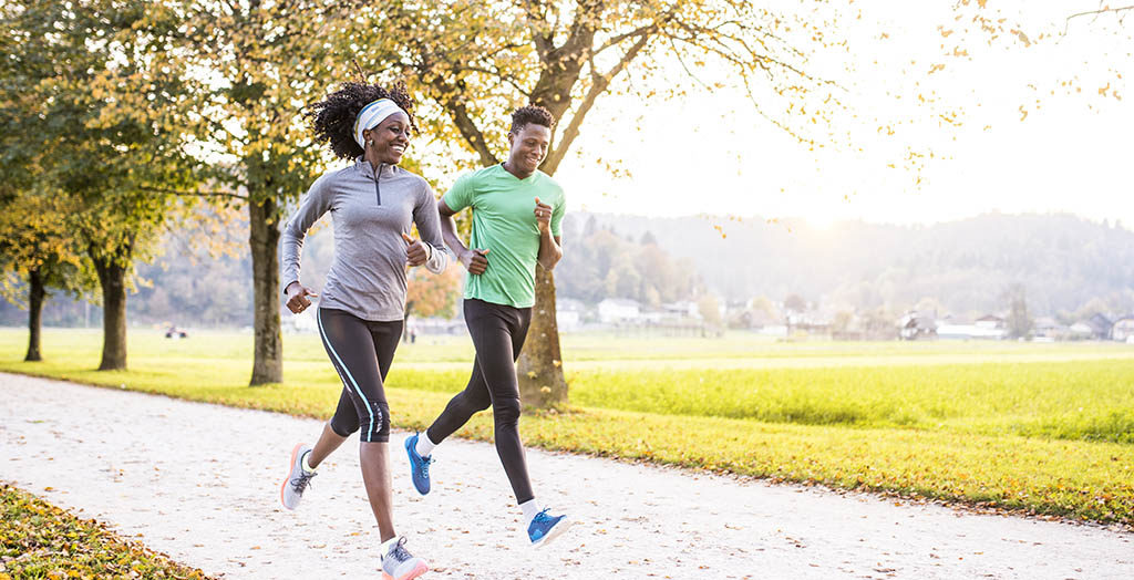 friends running together in nature