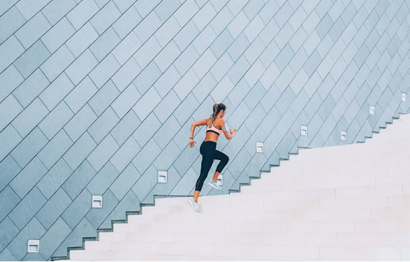 woman running up stairs