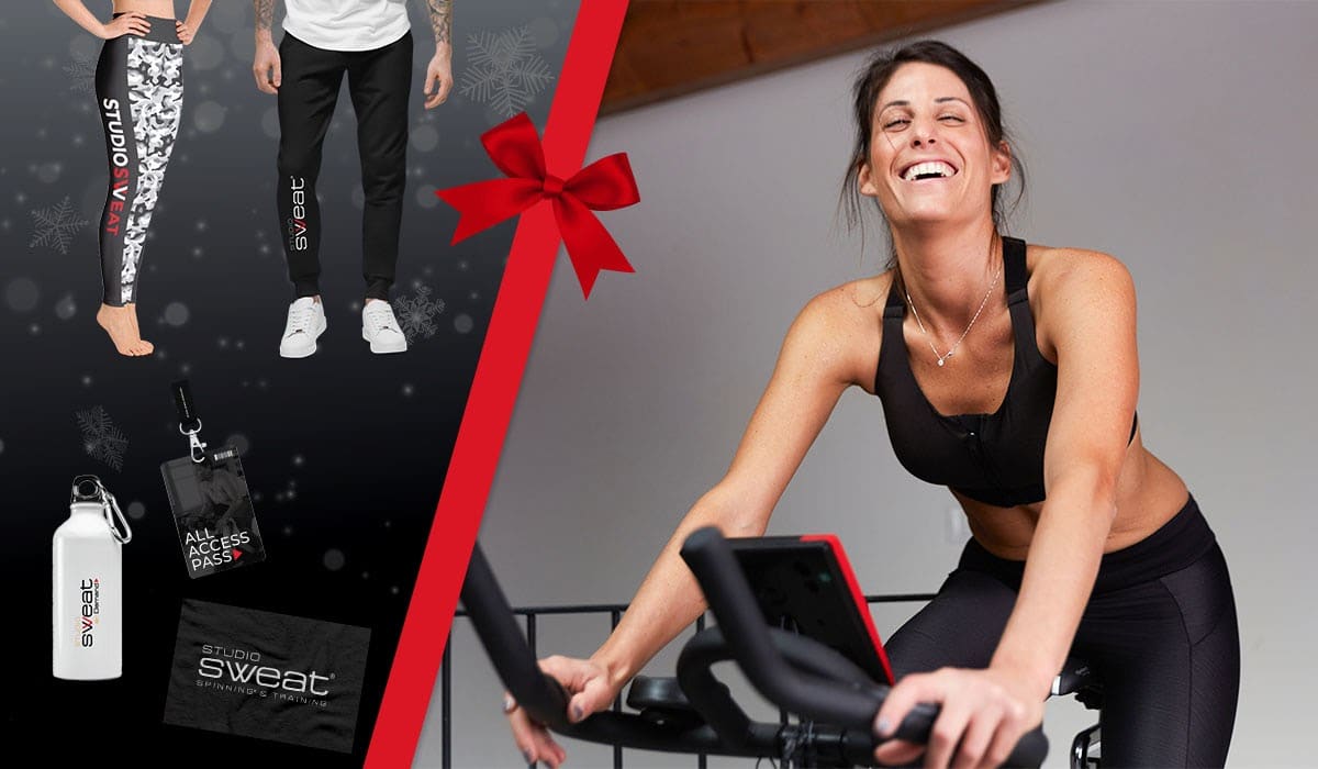 Red bow over several gifts and accessories for spin bike enthusiasts.