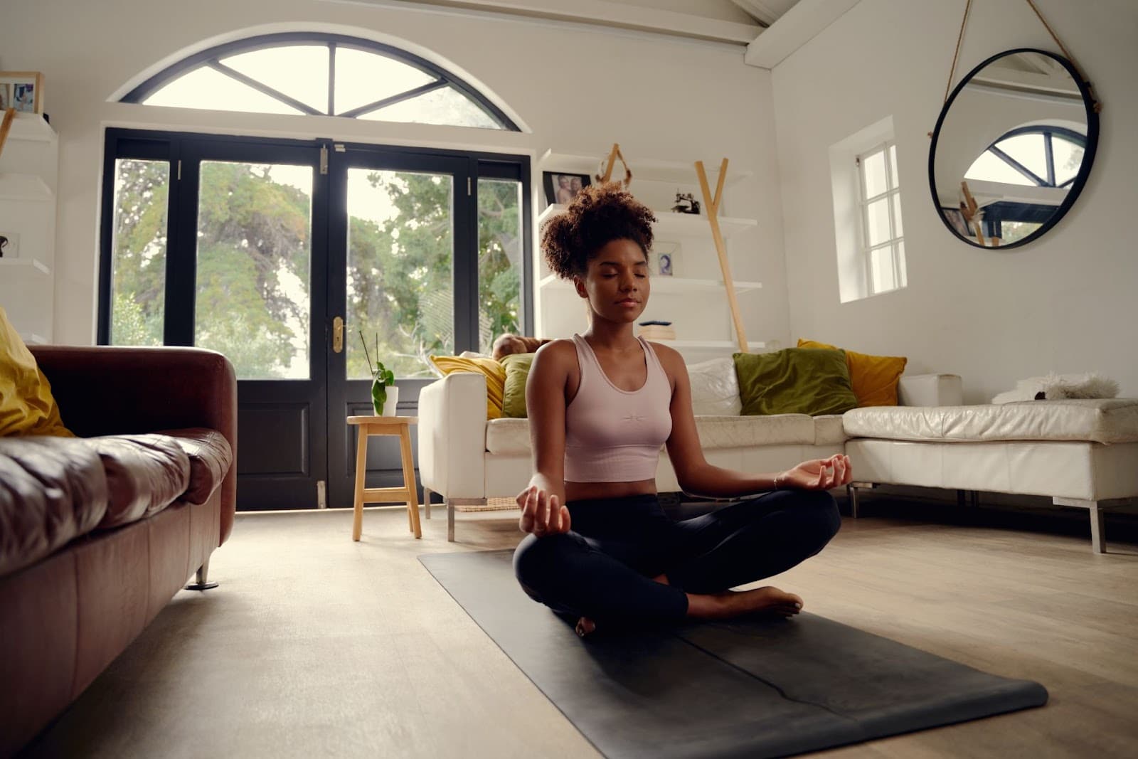 Young black fit woman doing yoga in her living room.