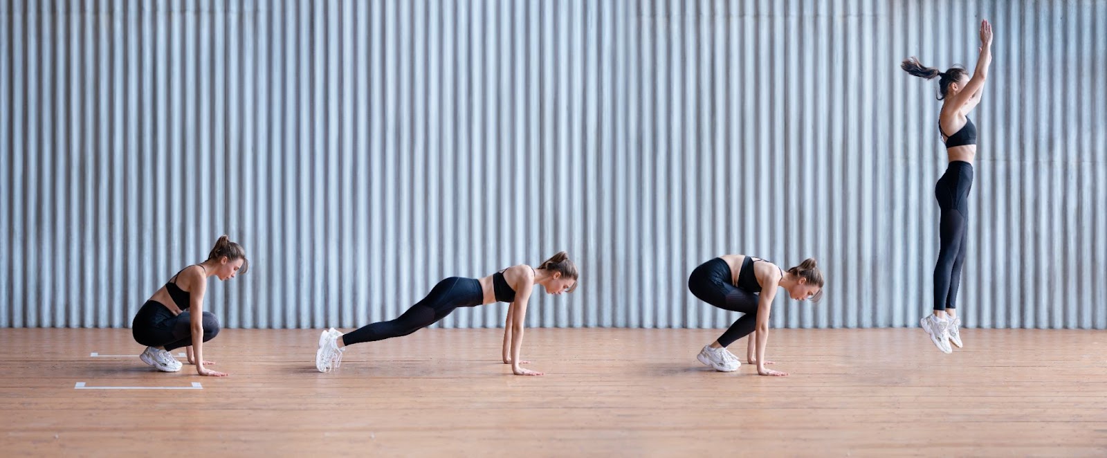 Active woman performing a burpee in a garage gym.