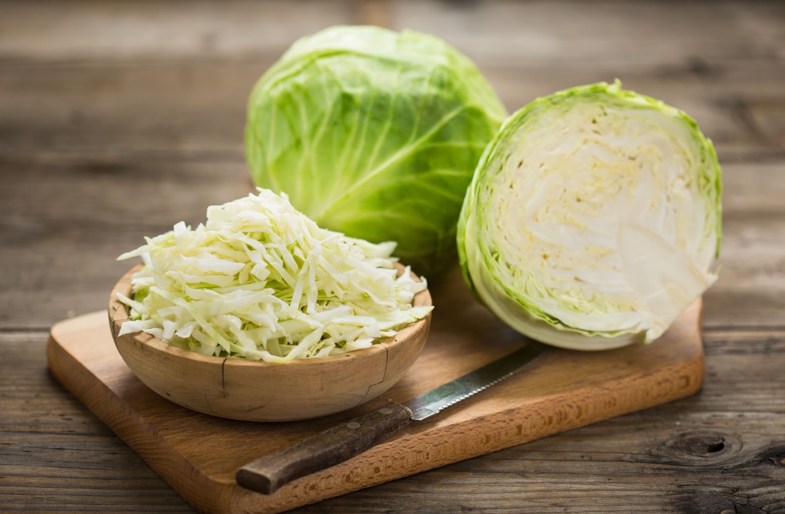 Cut and diced cabbage head on a wooden board.