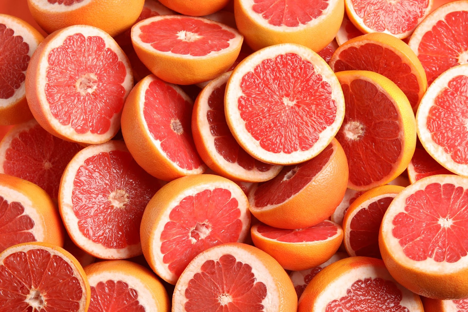 Multiple grapefruit halves shot close up.