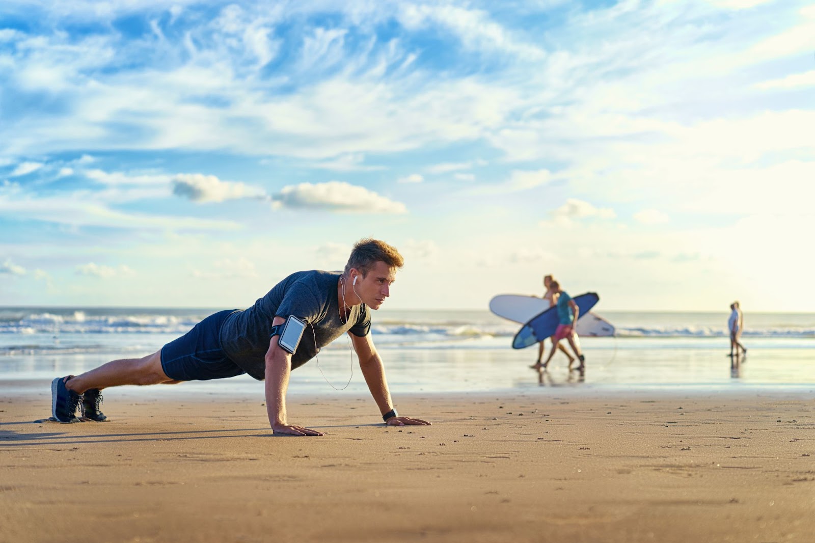 Blonde surfer man training on the beach