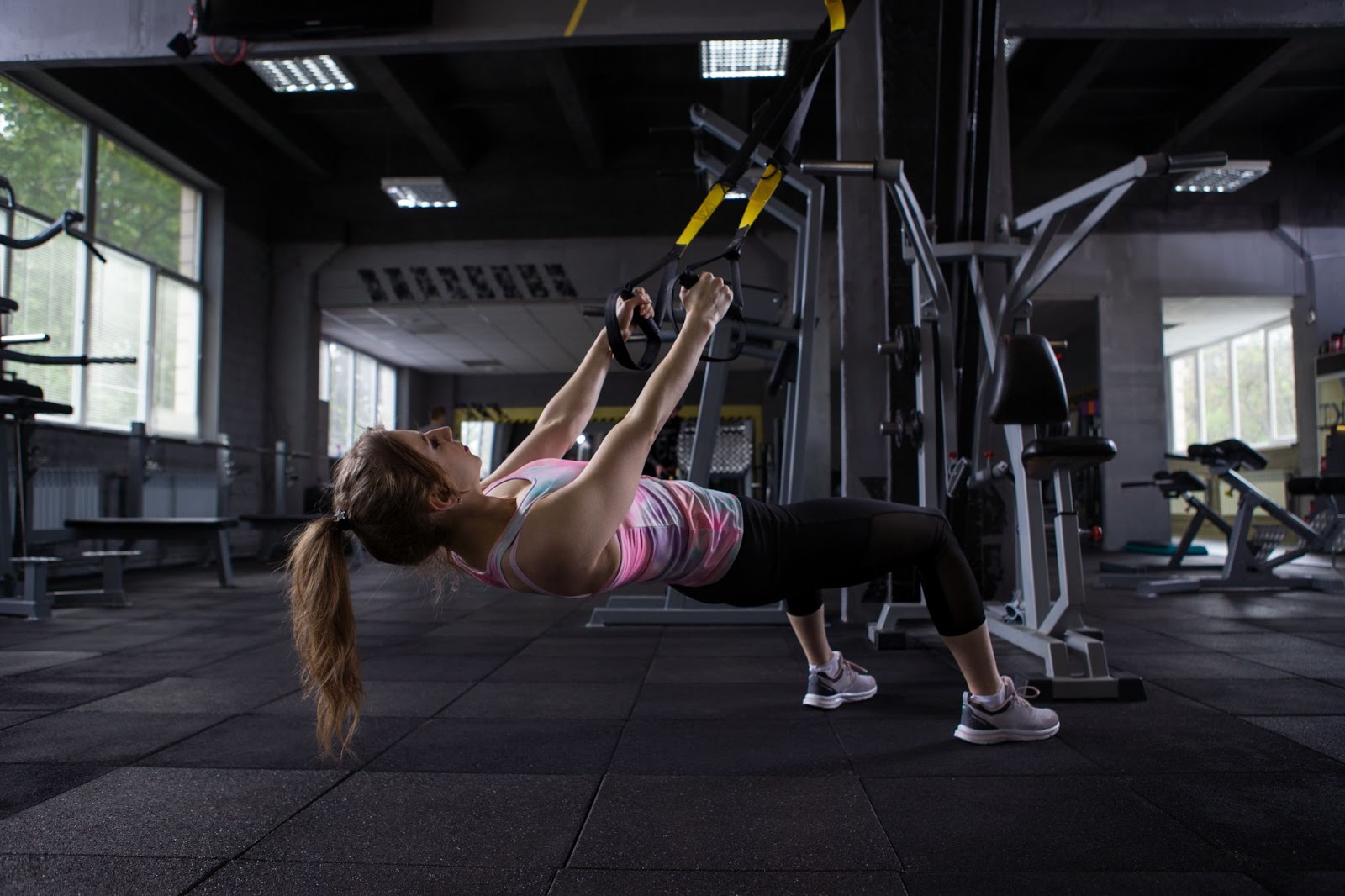 Woman performing TRX rows with her bodyweight