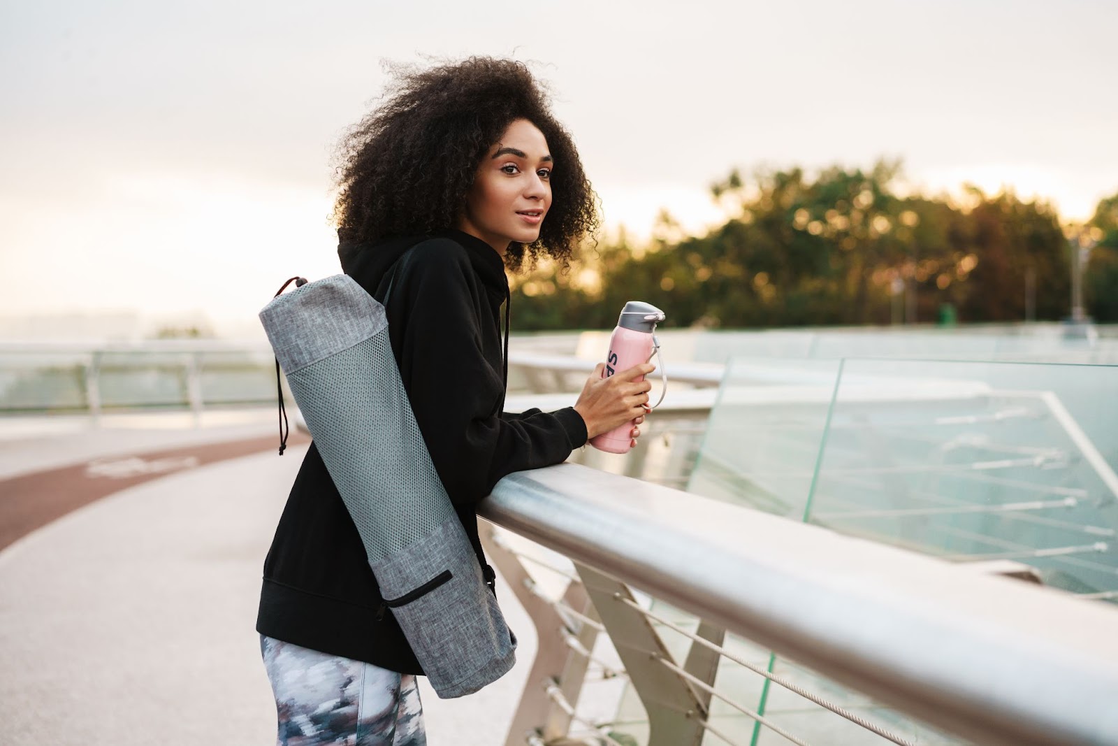 Attractive woman carrying a portable bottle of water in her hand