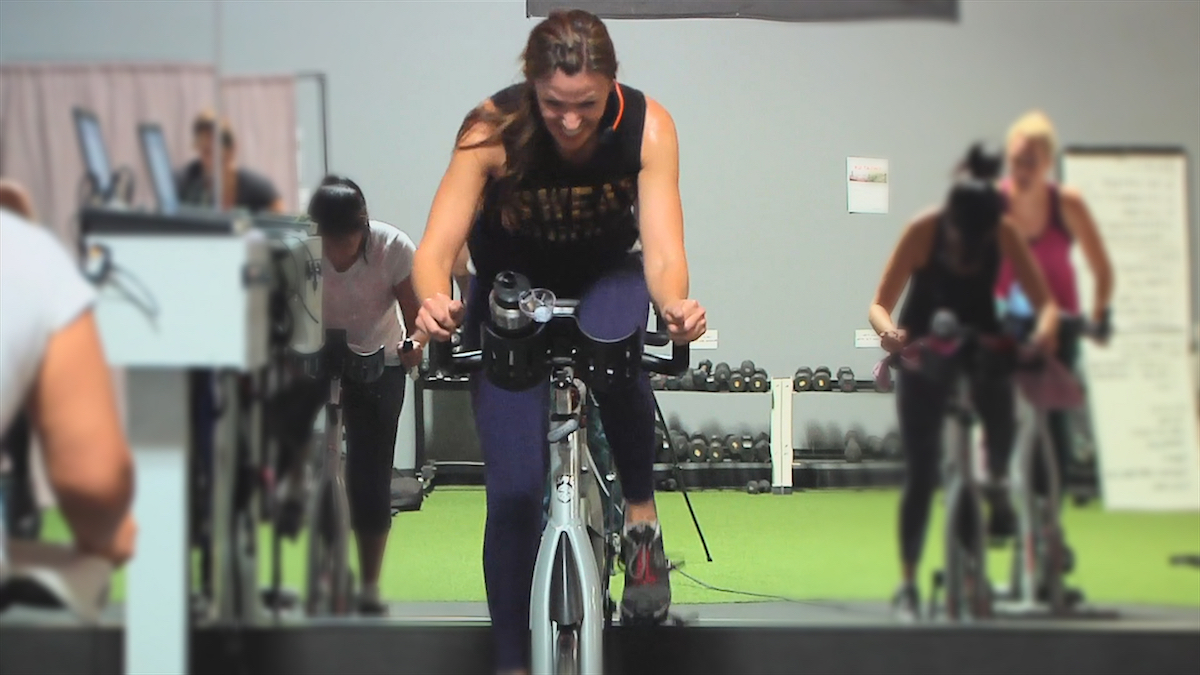 Image of Cat Kom from Studio SWEAT onDemand doing a Spin class workout