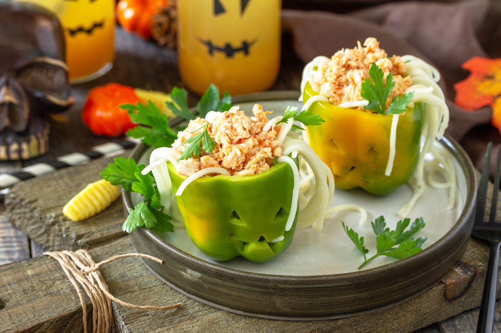 Bell peppers cut into halloween shapes and stuffed with zoodles and bolognese