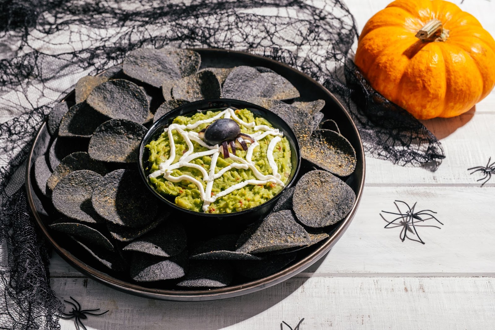 Festive bowl of guacamole decorated for halloween