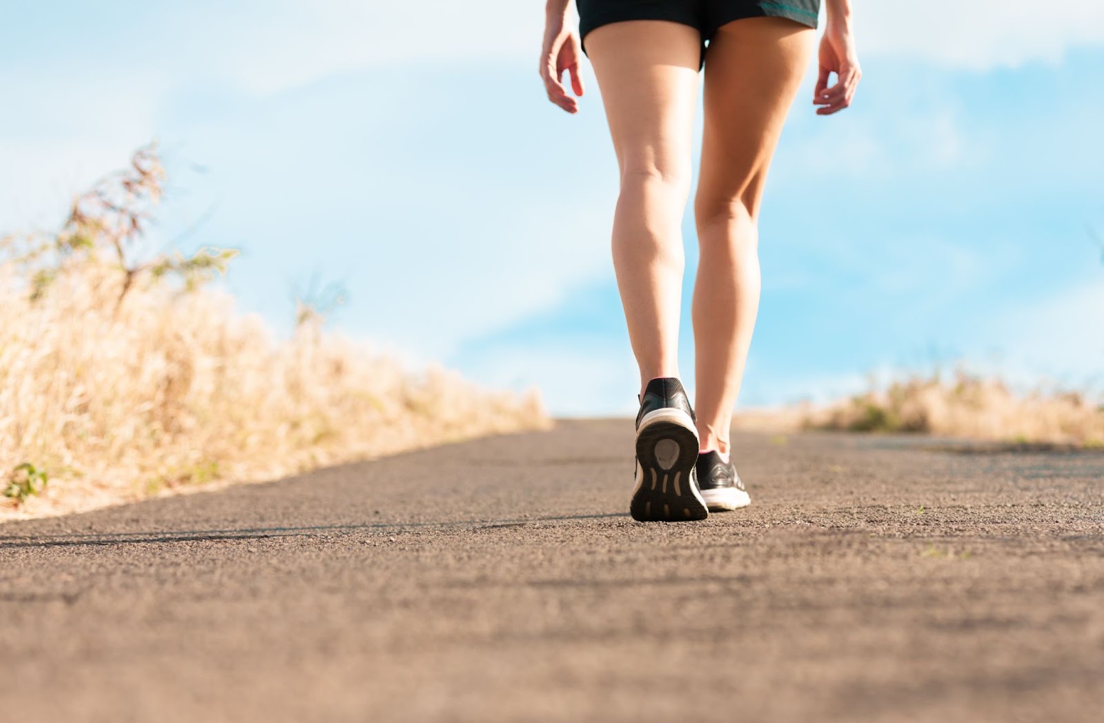 Healthy woman walking, with a closeup on her calves