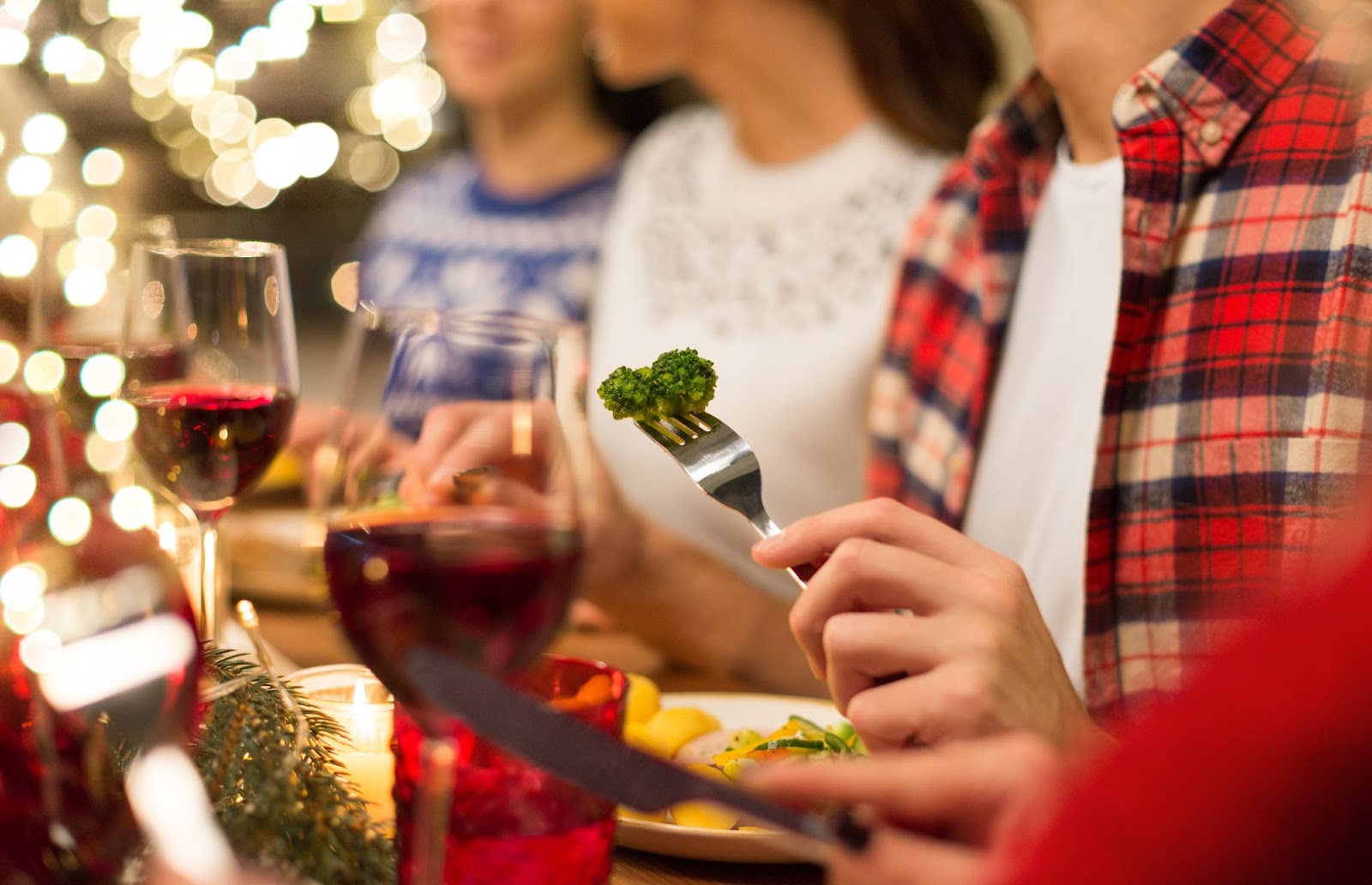 Person choosing to eat broccoli during holiday feast