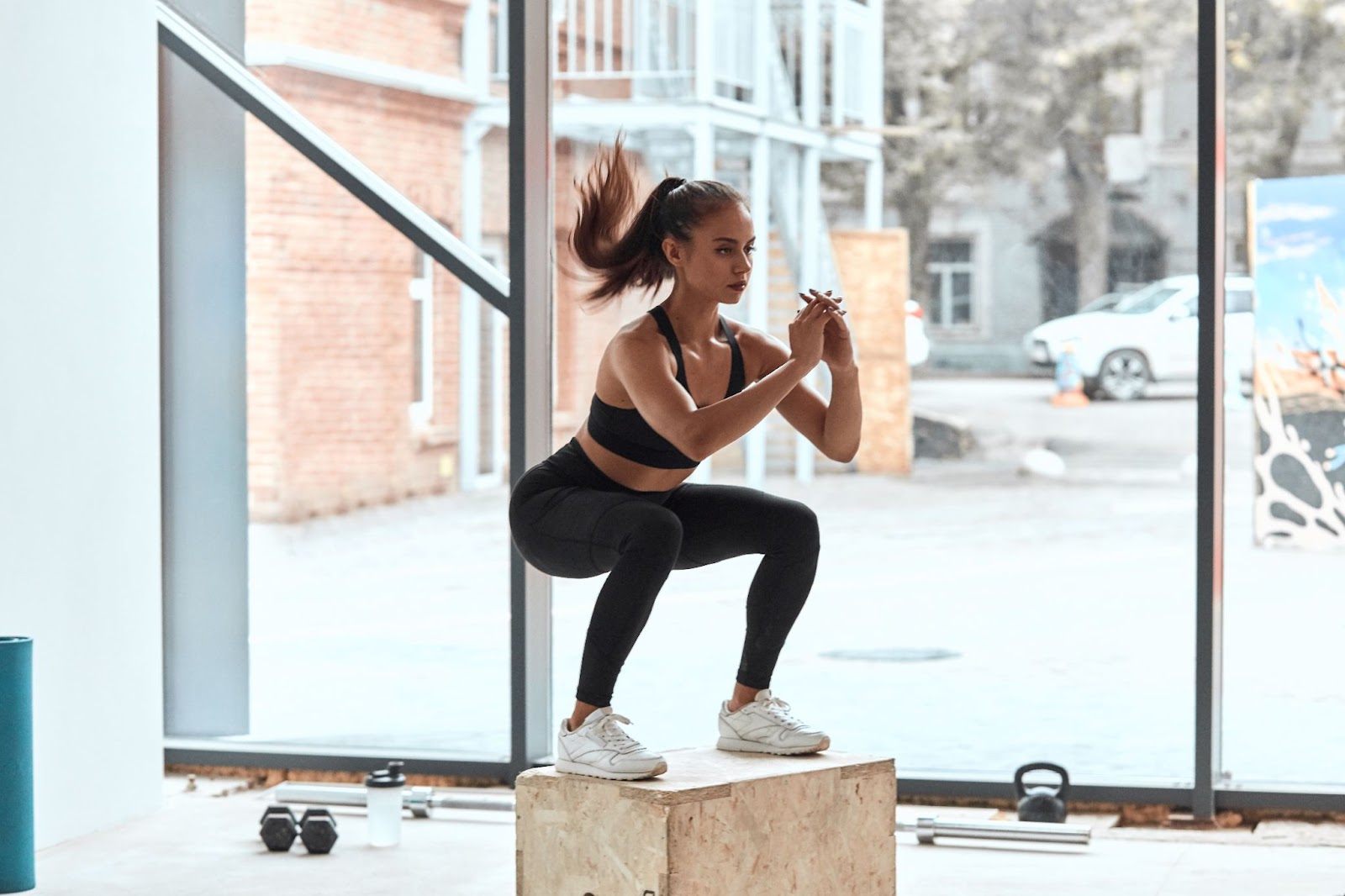 Fit young woman doing a jumping squat Boot Camp exercise