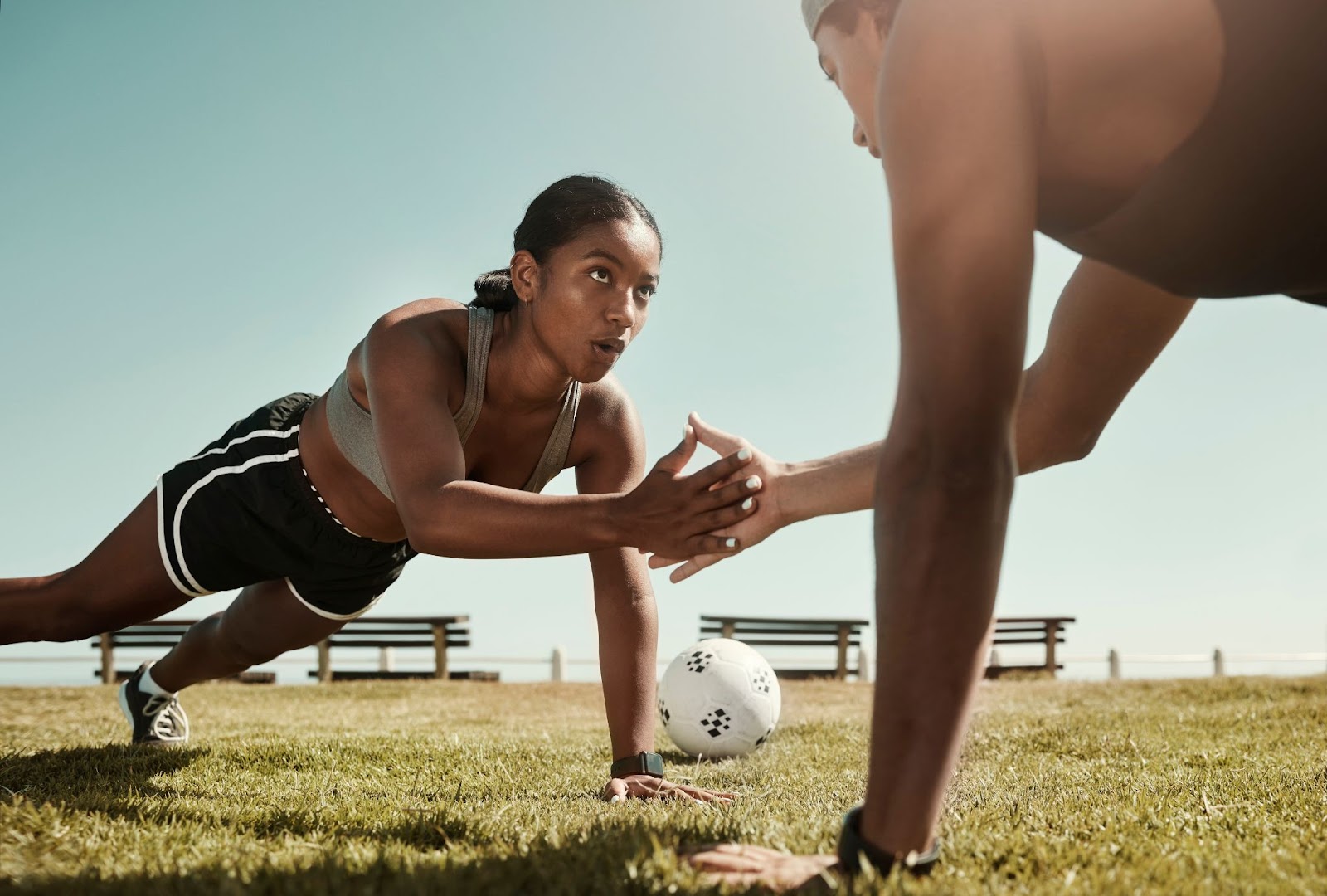 Couple doing push-ups with a high five after each movement