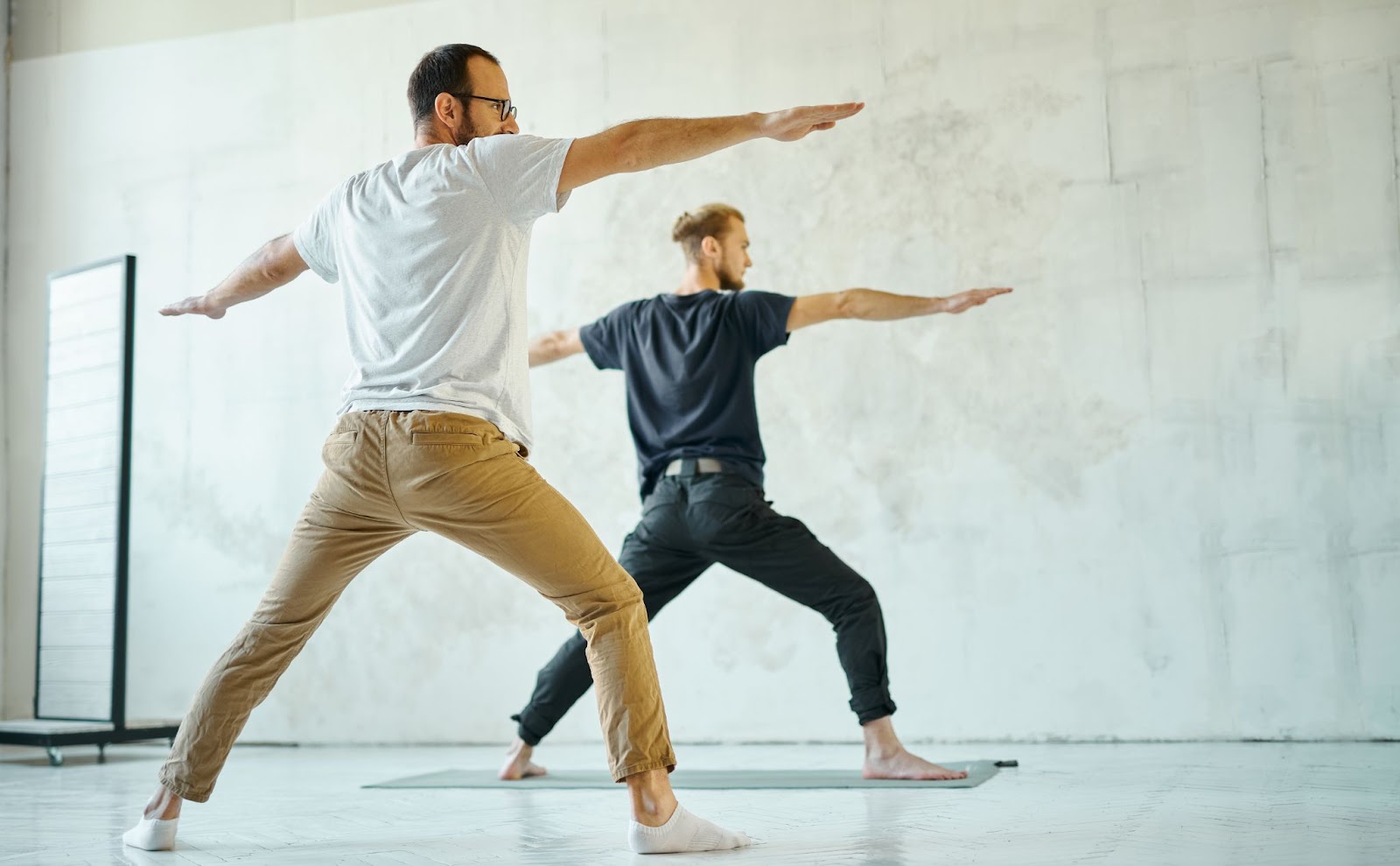 two men doing yoga