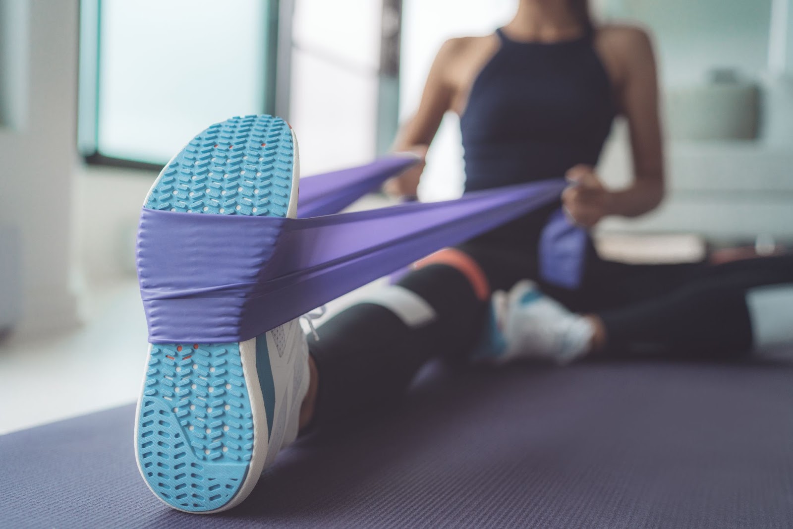 Close up of a woman stretching with a resistance band
