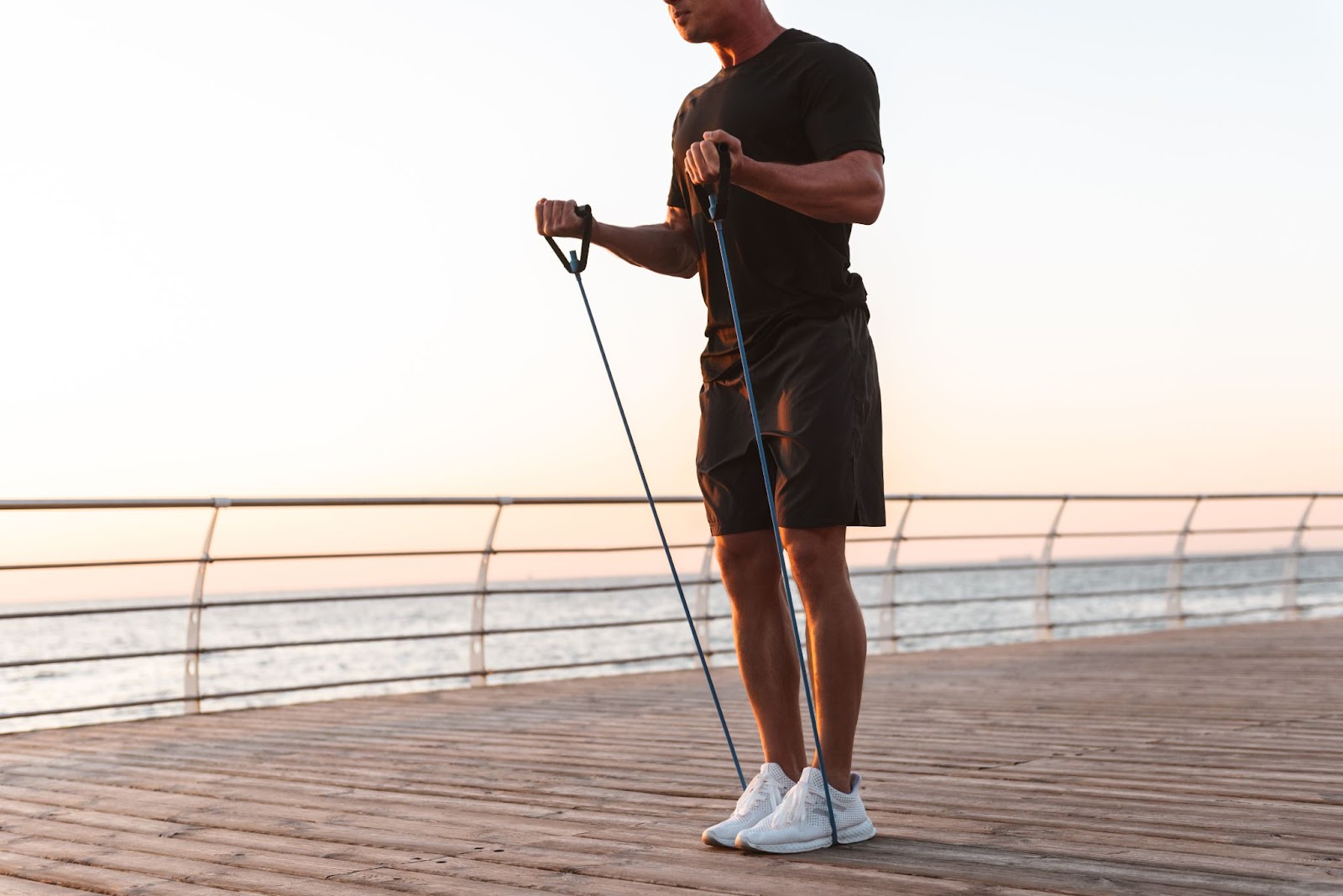 Man using a resistance band at the beach