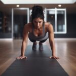 Fit young woman doing a push up in an empty gym