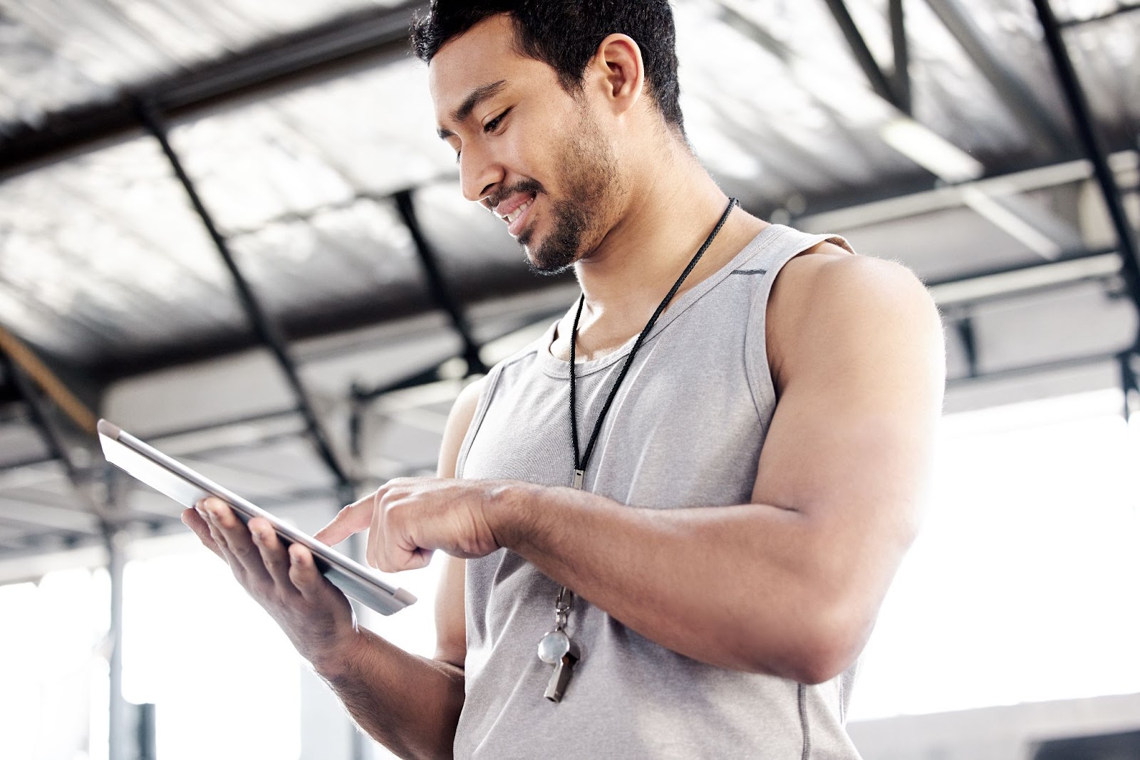 Image of a young gym owner holding a clipboard