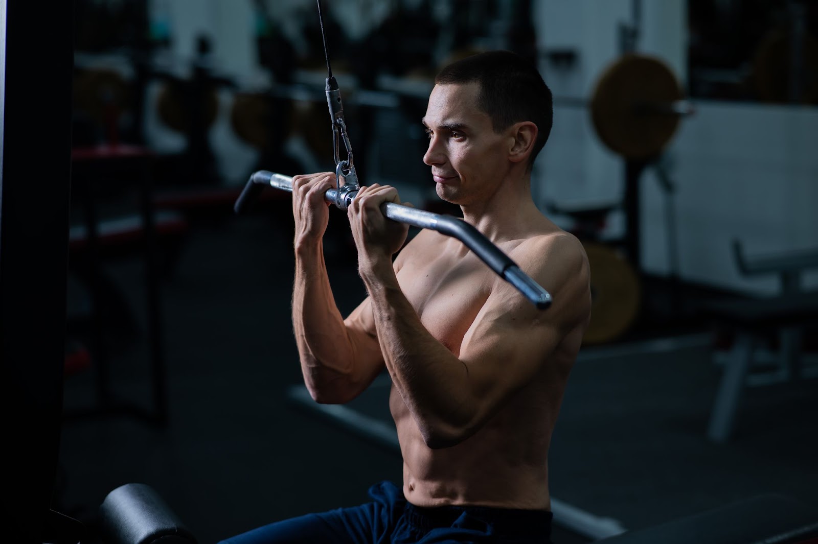 Man doing a bicep pull down on a machine