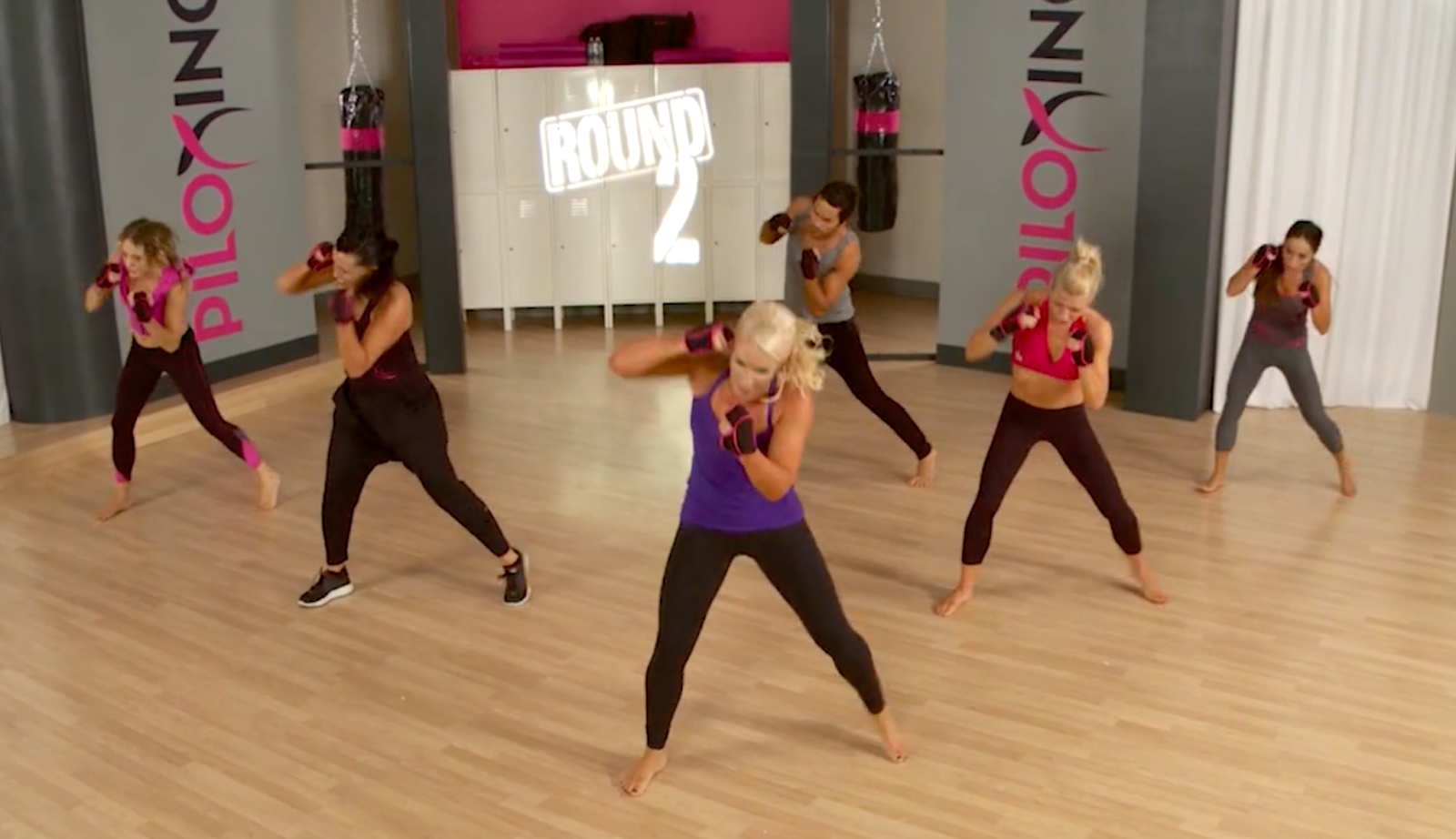 Still image of a Piloxing group fitness class
