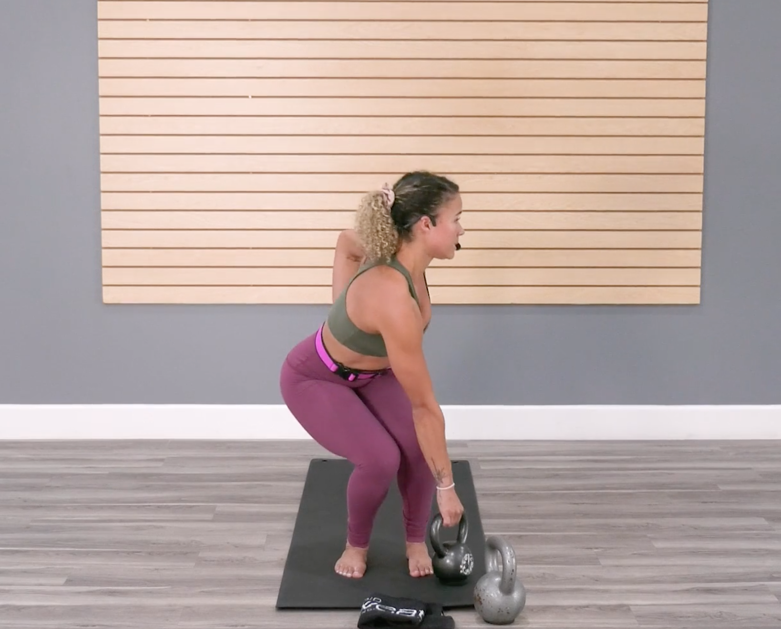 Fitness Trainer performing a twisting chair sit