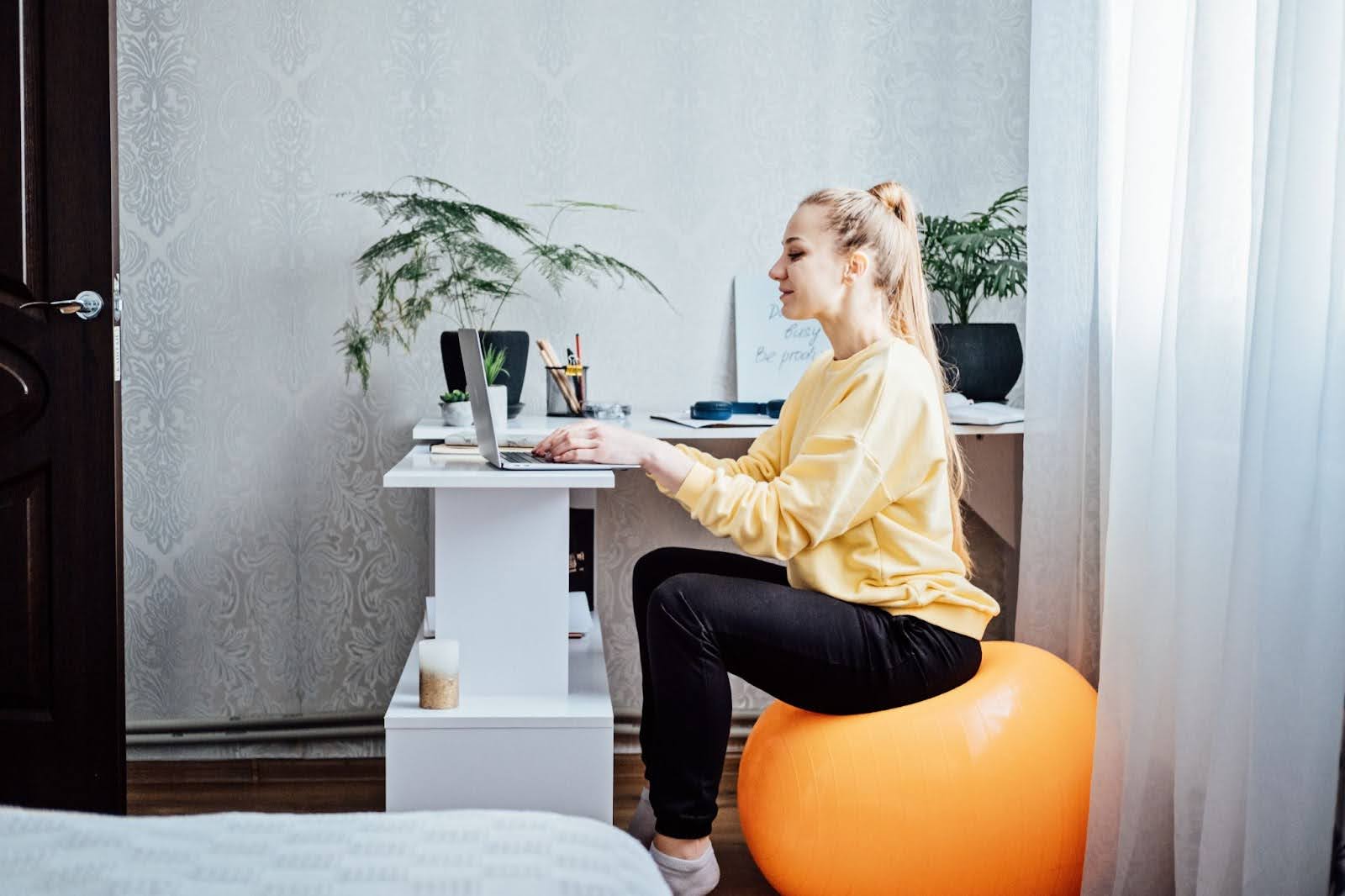 Woman sitting on an exercise ball at work