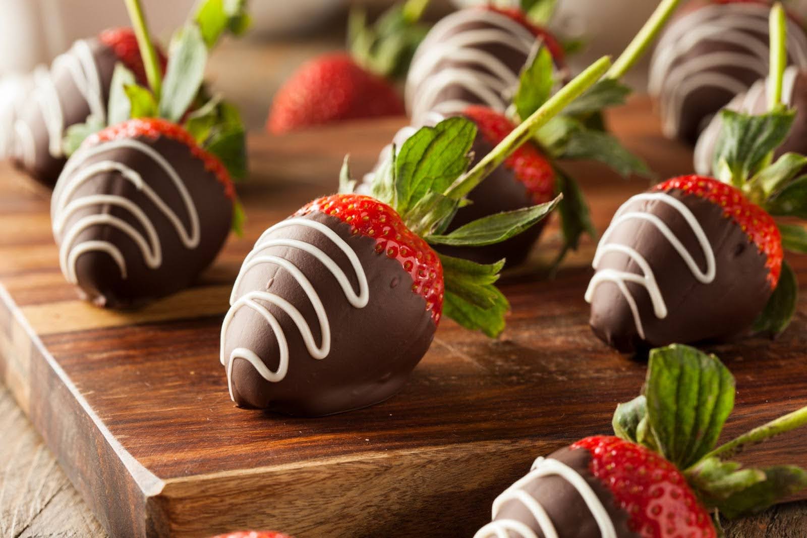 Chocolate covered strawberries on a wooden board