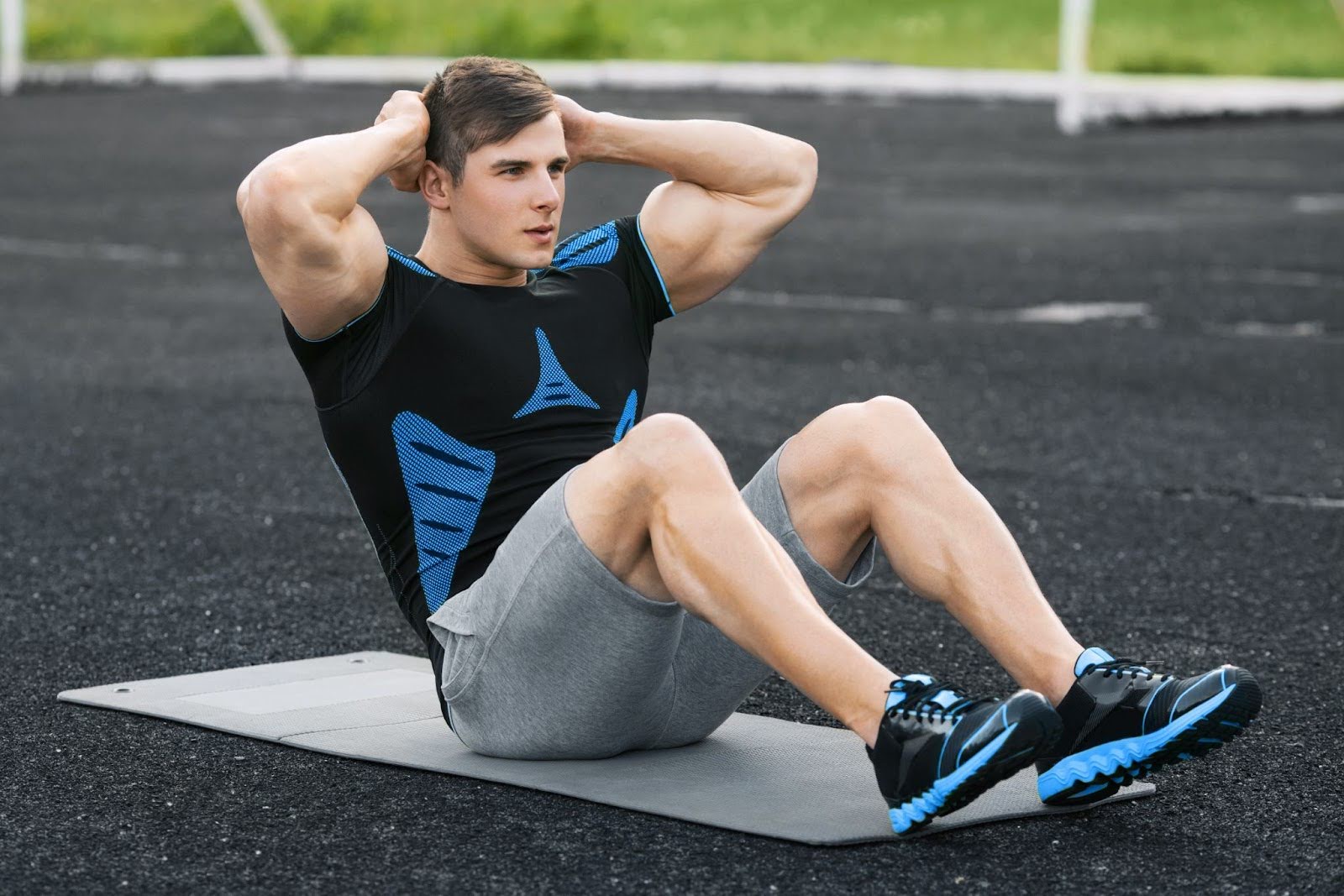 Fit young man outside performing a sit up exercise