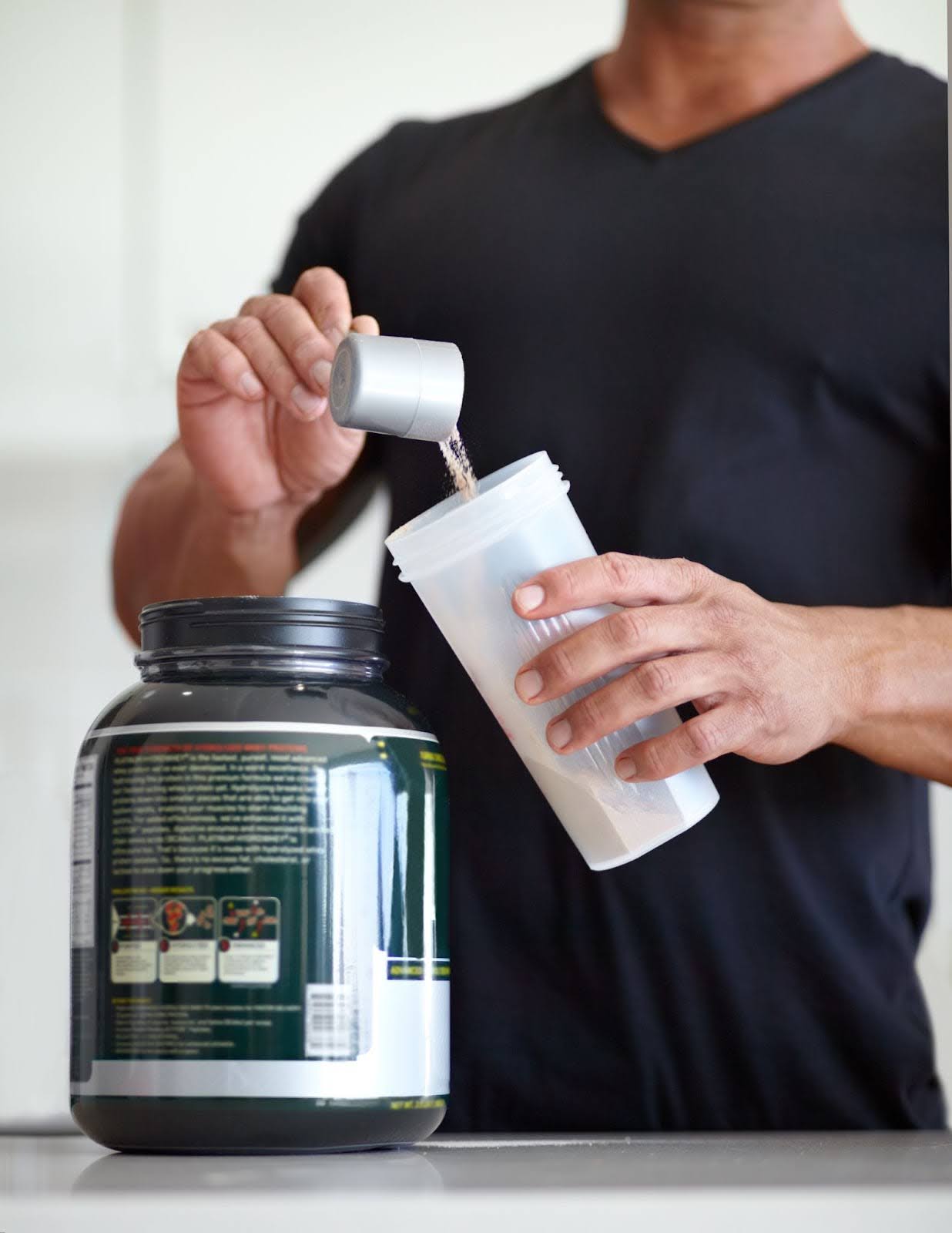 Man drinking pre-workout supplement before going to the gym