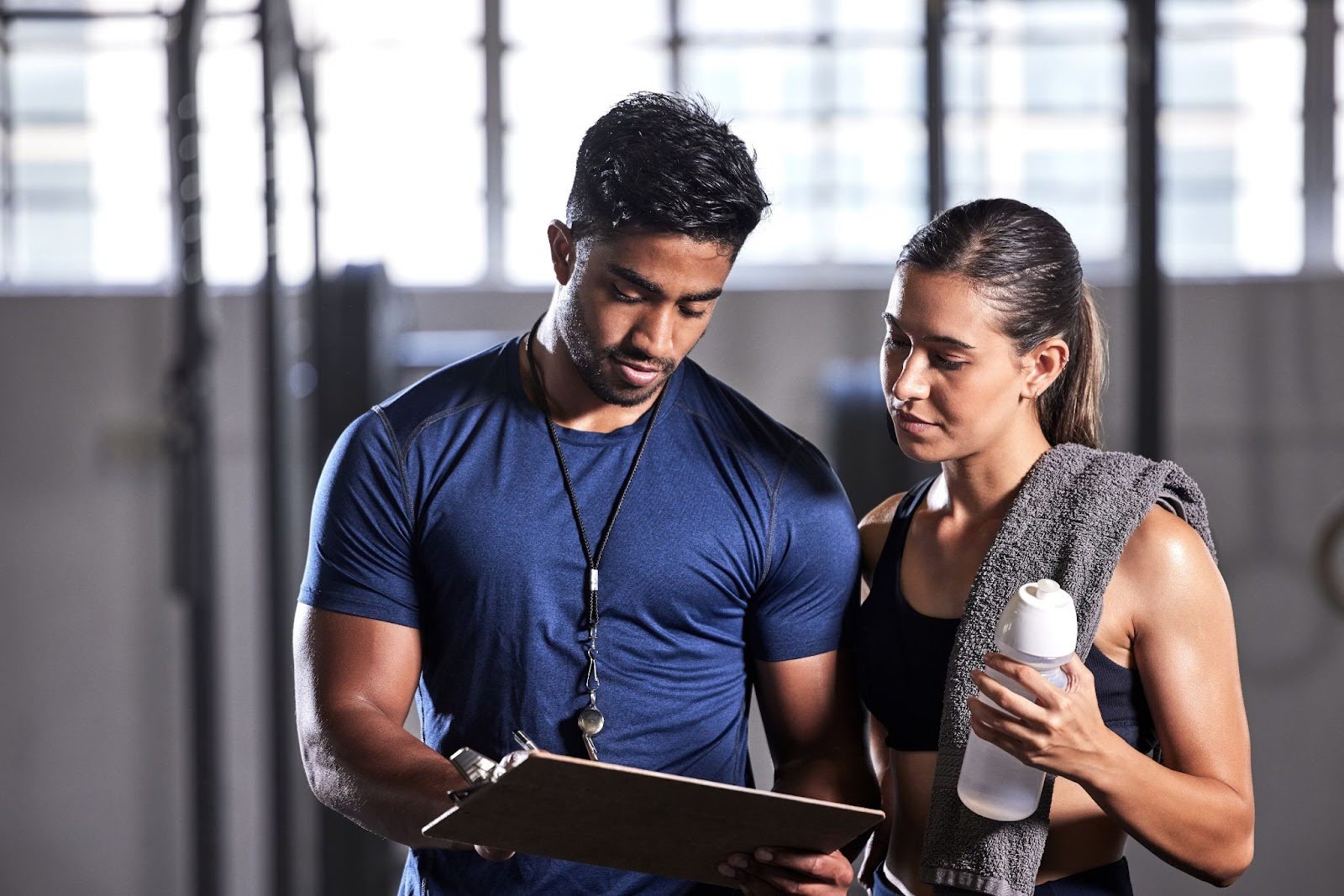 Personal trainer giving customized guidance to a fitness challenger