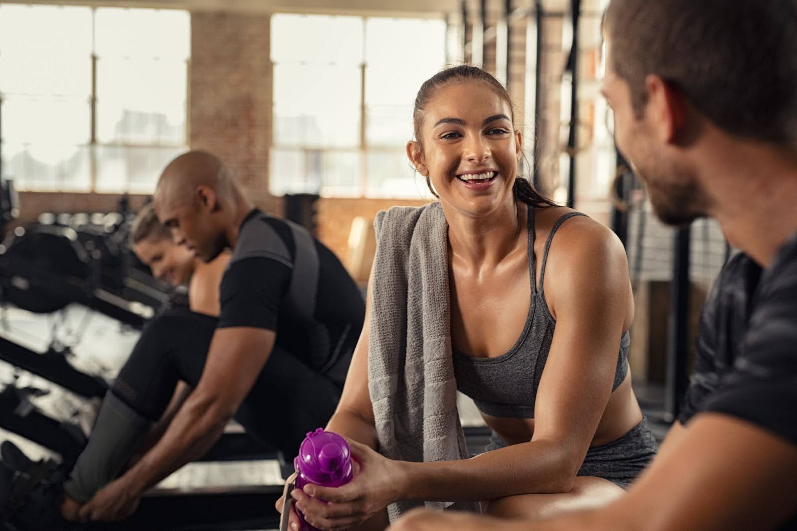 Smiling fit woman at a gym taking a fitness challenge