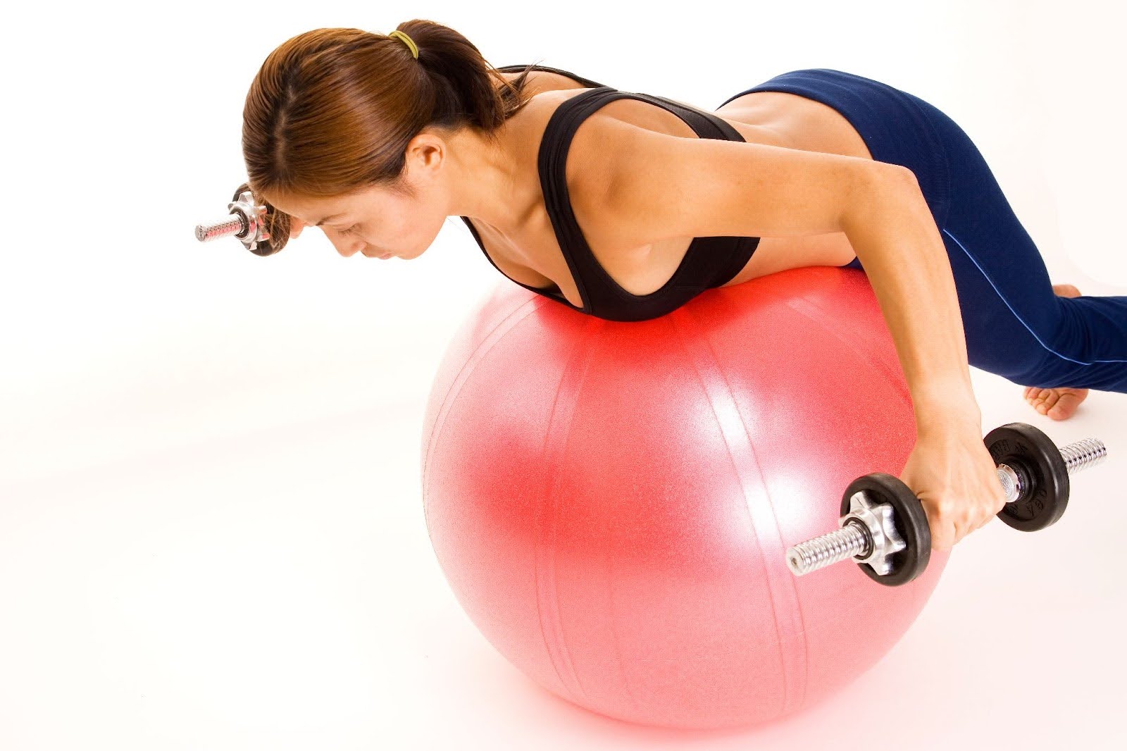 Image of fit woman performing reverse flys on an exercise ball at home