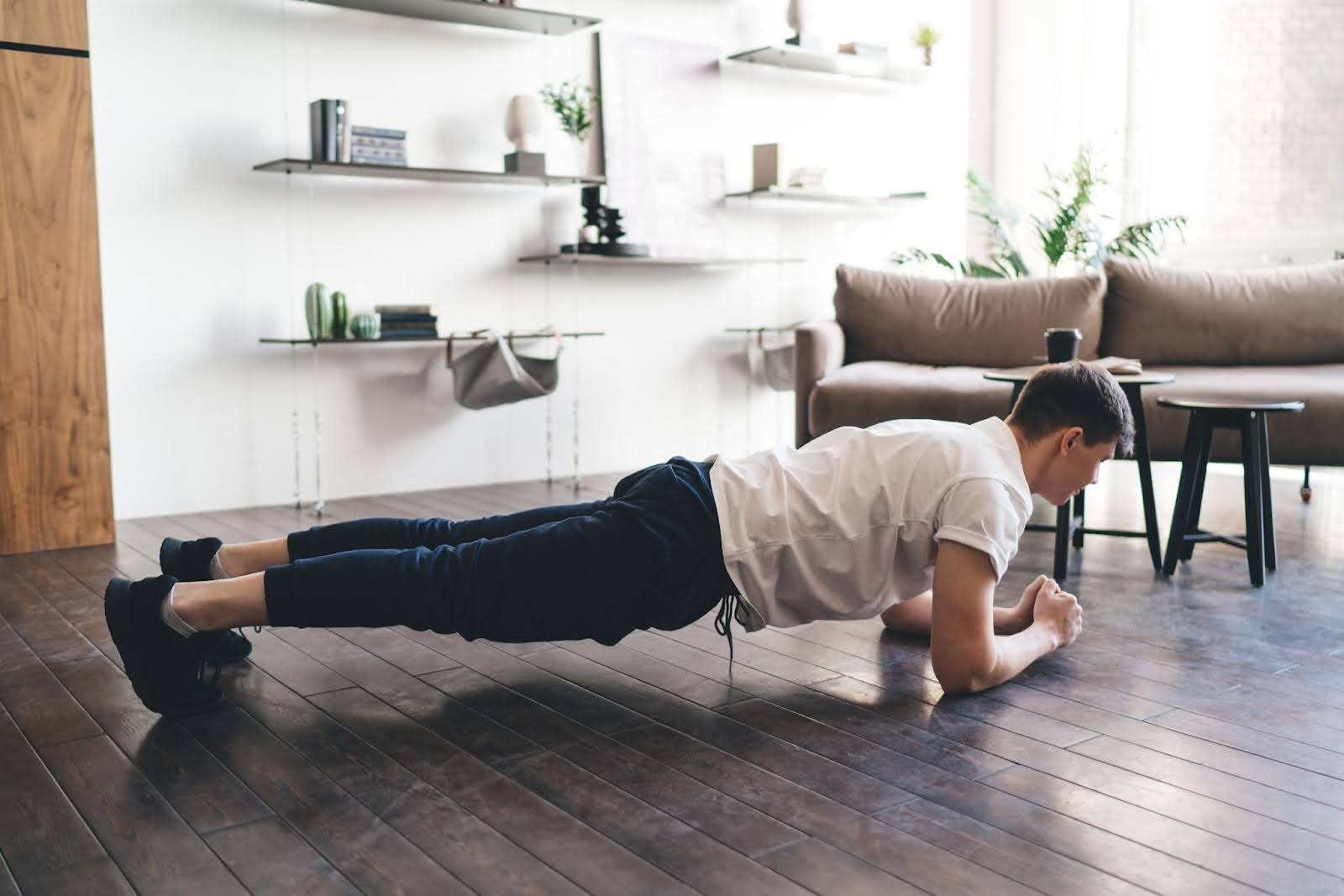 Image of man doing a forearm plank at home