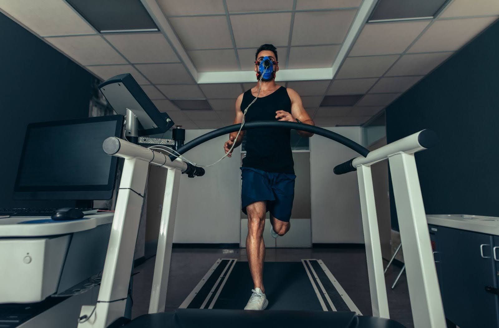 Fit man running on a treadmill in a scientific health and research lab