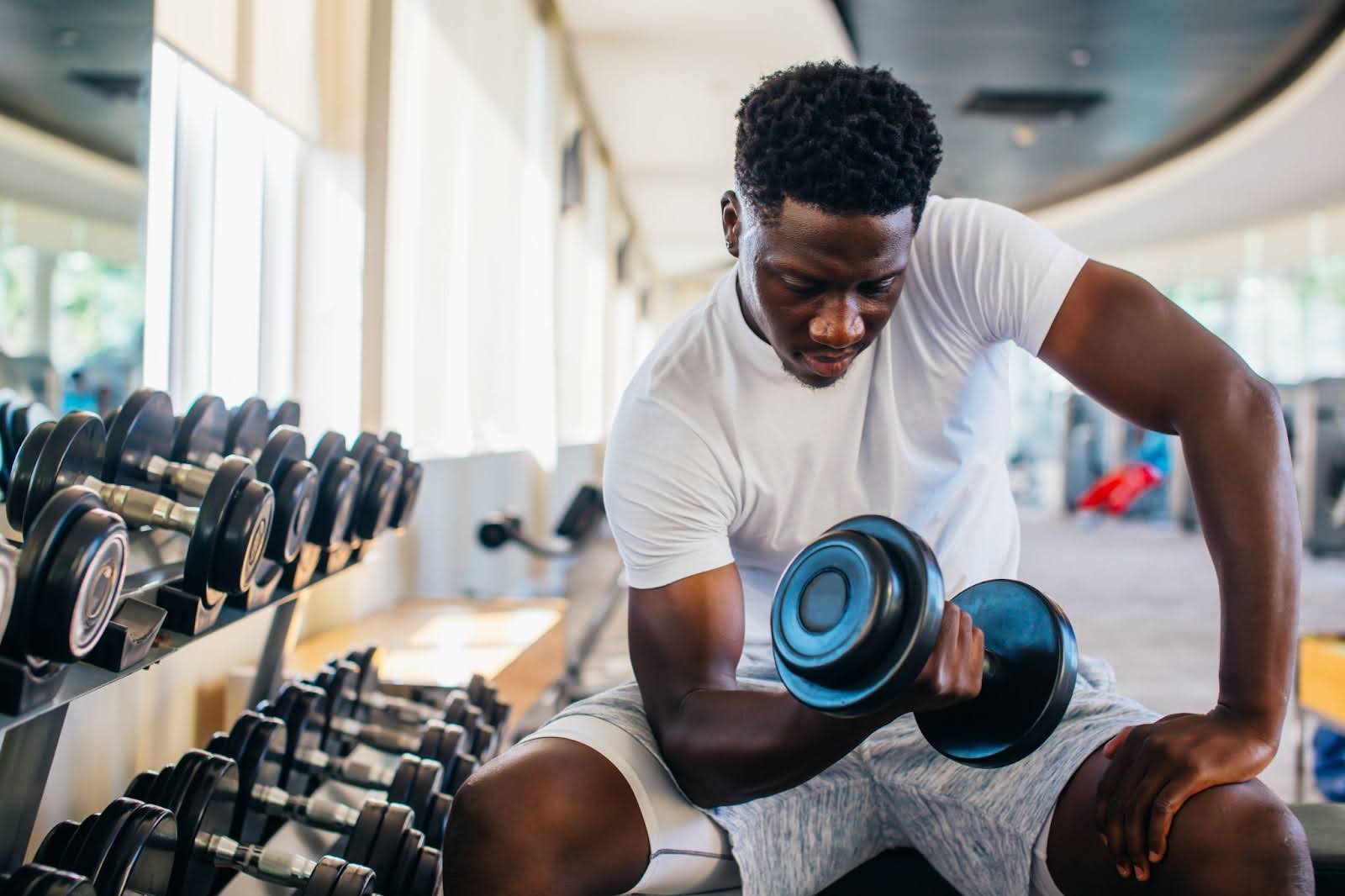 Man performing a perfect bicep curl in a gym