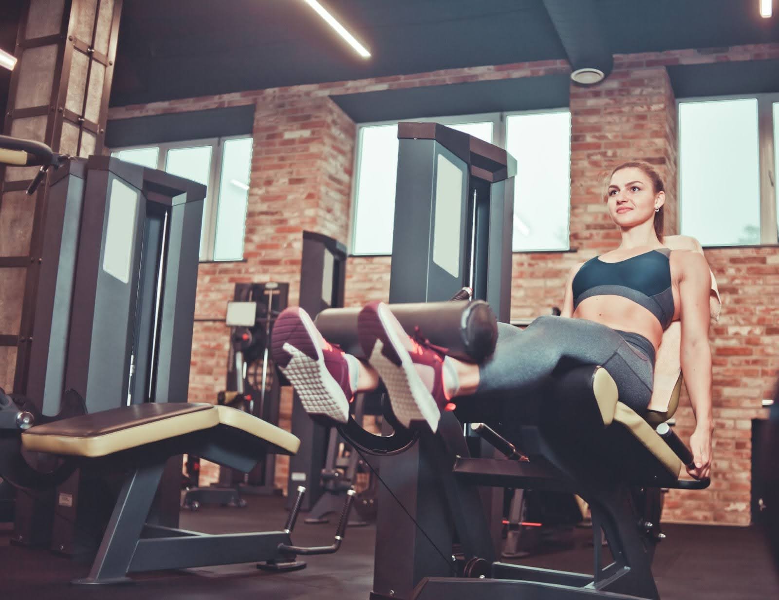 Woman doing a leg extension exercise on a machine