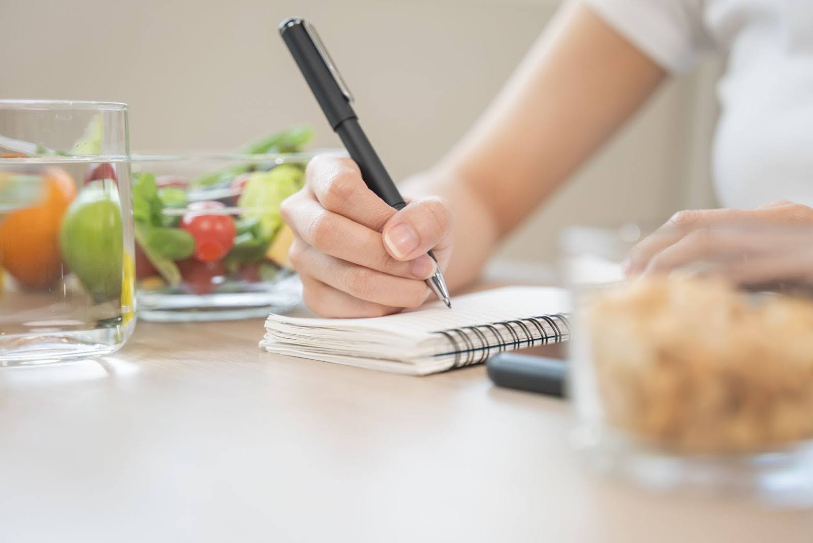 Closeup of a person’s hand tracking their macronutrients